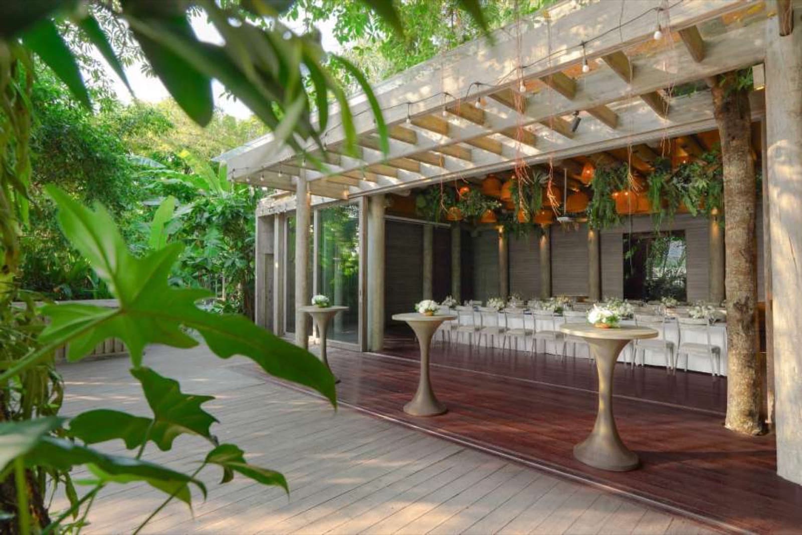 Cocktail tables on An House's covered garden terrace