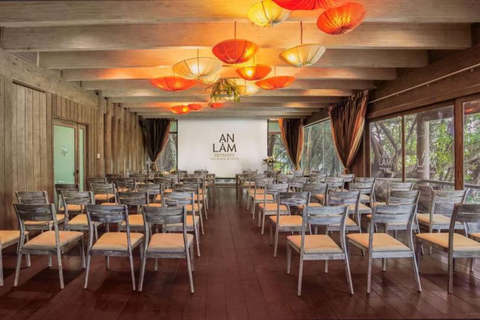 Theatre seating beneath red pendant lights in Luc Binh