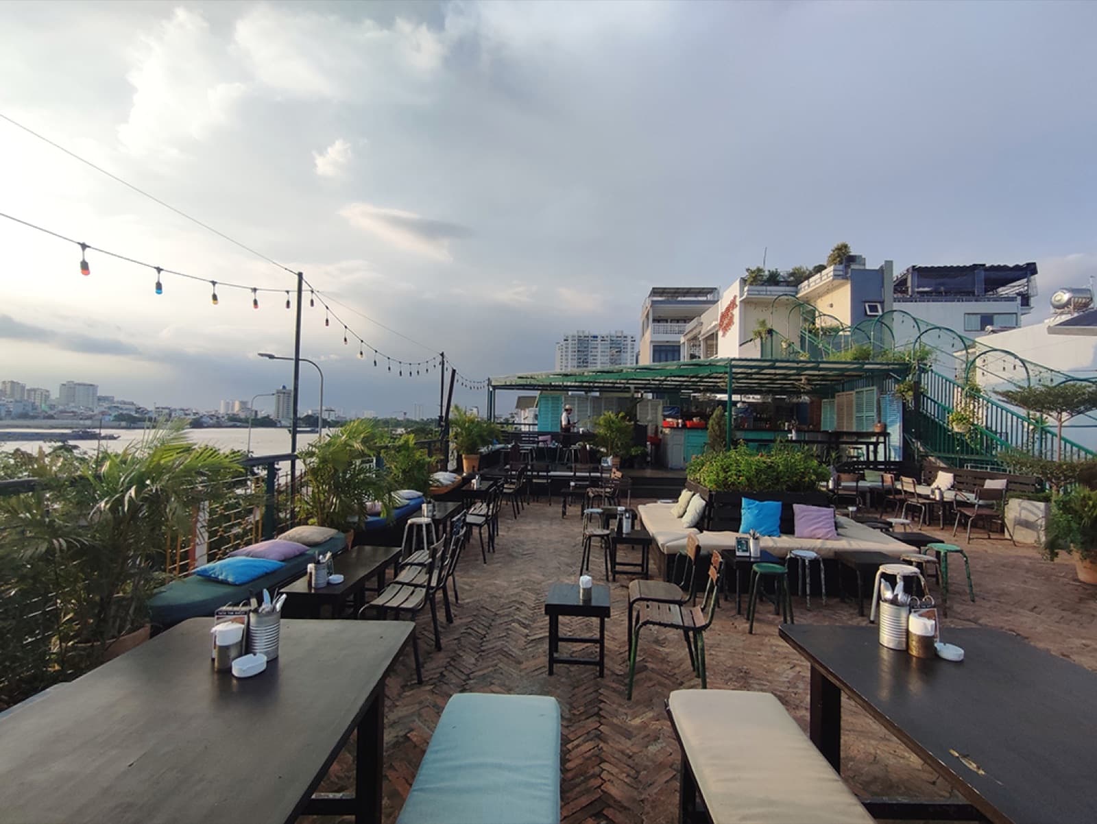 Rooftop seating overlooking the river at Le Café des Stagiaires