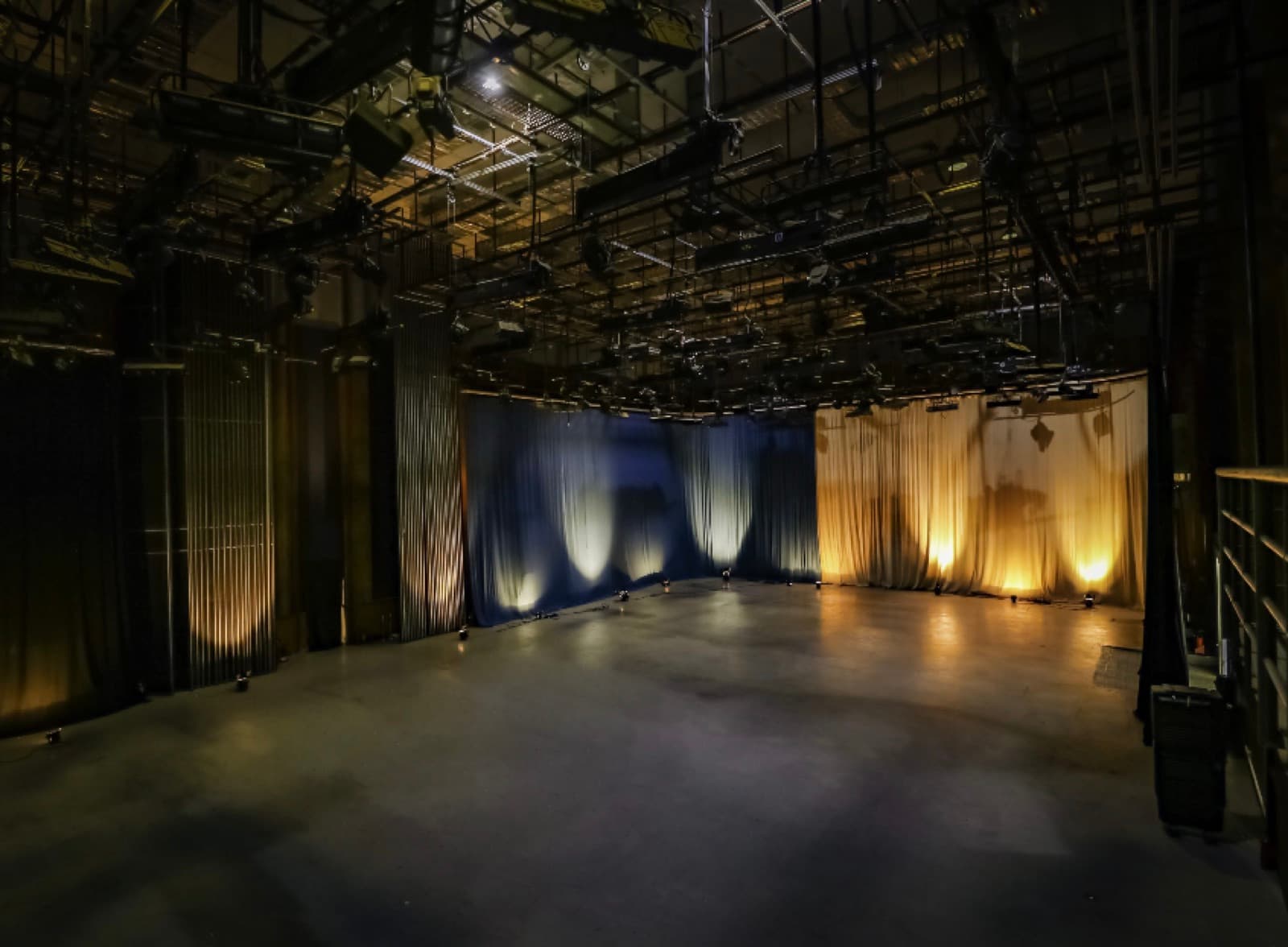 Stage 1 empty sound stage with rigging and curtain backdrop