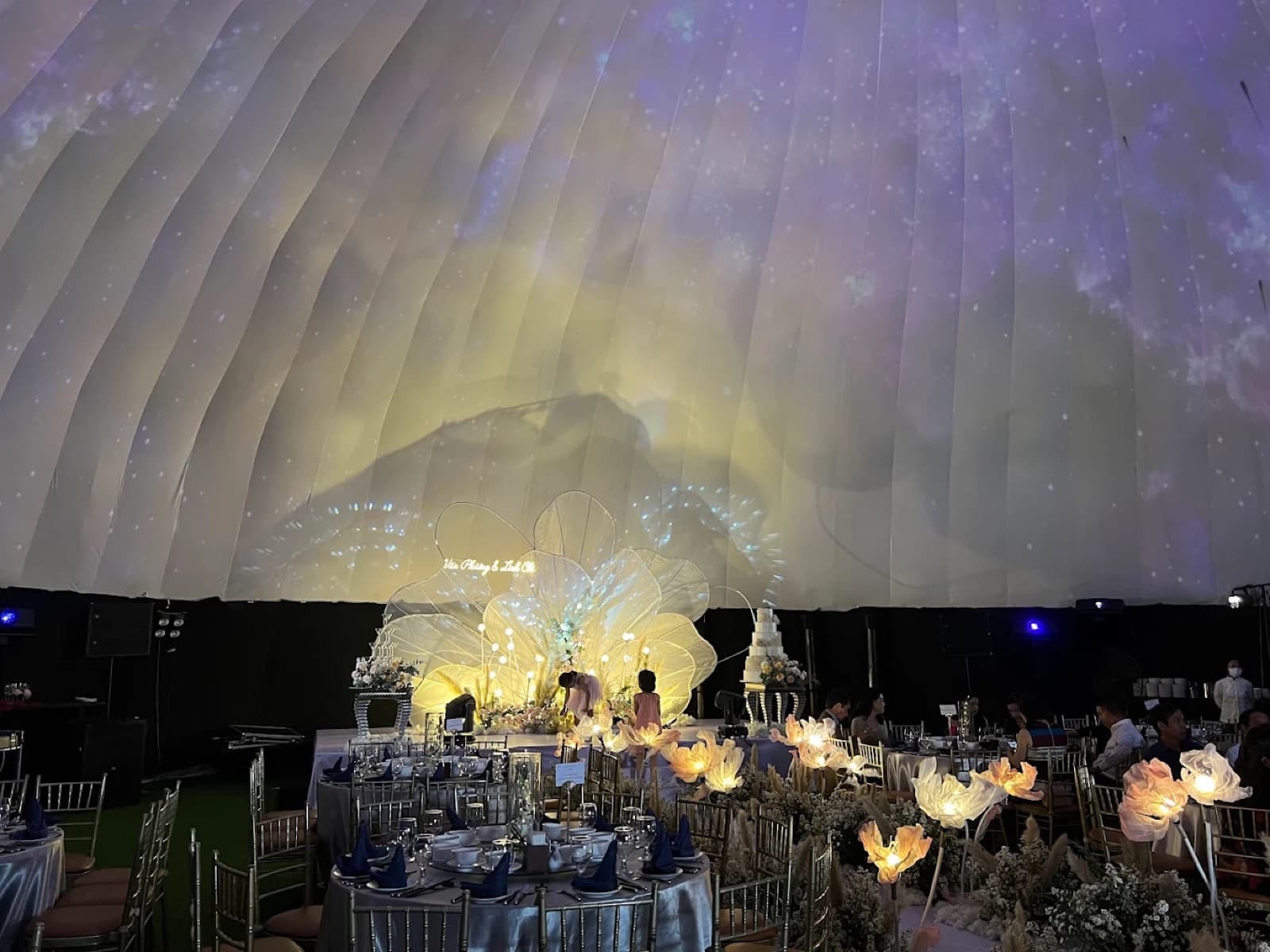 Dome Art Theater interior with full-dome 3D mapping projection over long banquet tables