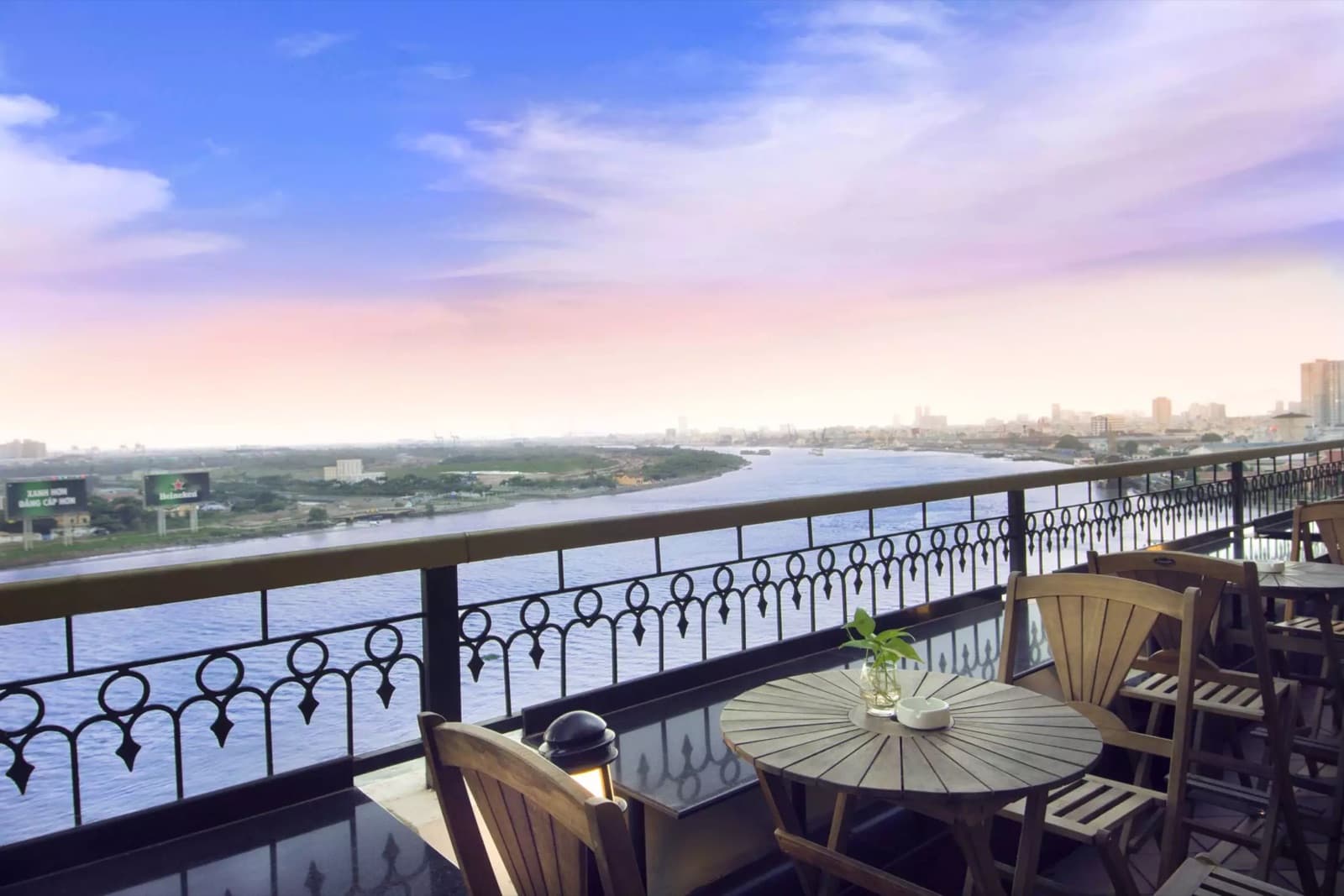 M Bar riverside terrace at Hotel Majestic Saigon at dusk overlooking the Saigon River