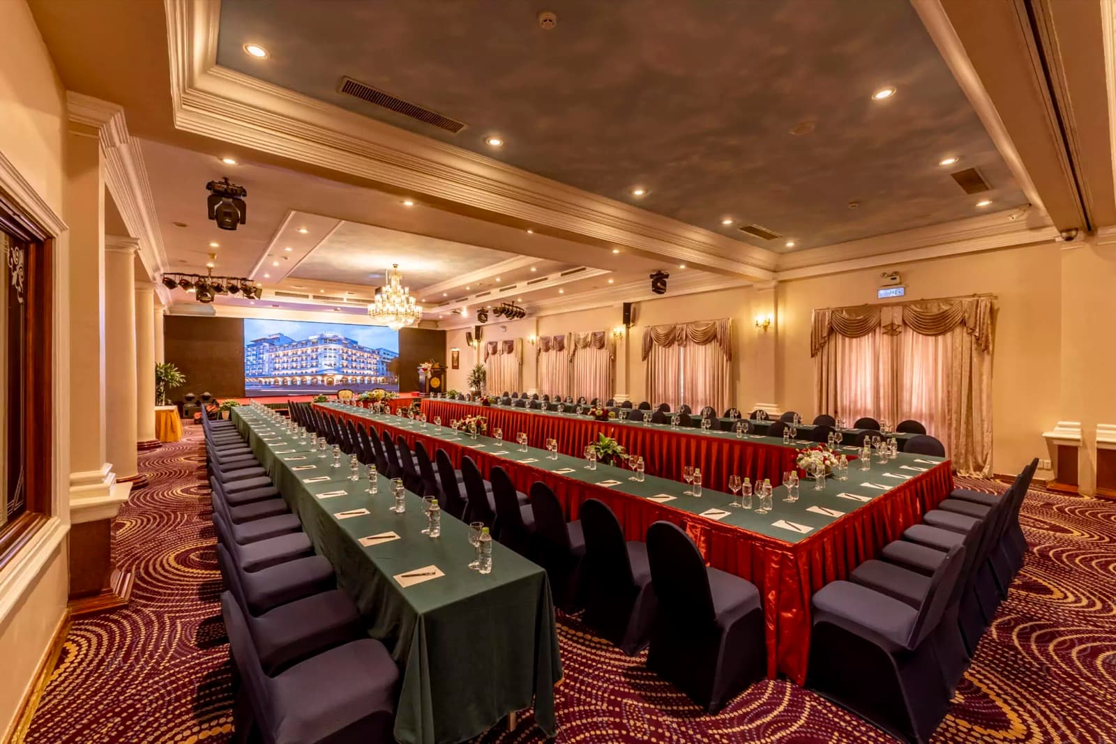 Prima Ballroom AB arranged in a U-shaped conference layout with stage and screen
