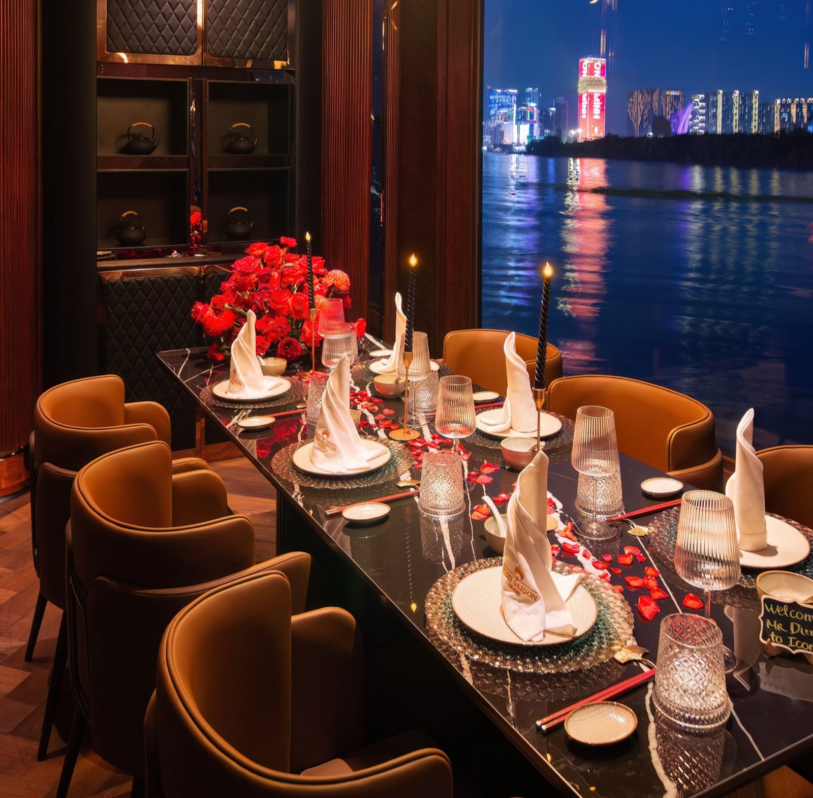 VIP Room 1 aboard ICON Saigon dressed for a private dinner, with candlelight and river-view windows