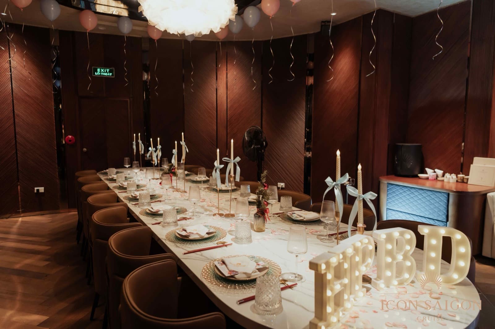 VIP Room 2 aboard ICON Saigon decorated for a birthday celebration with balloons and a lit table