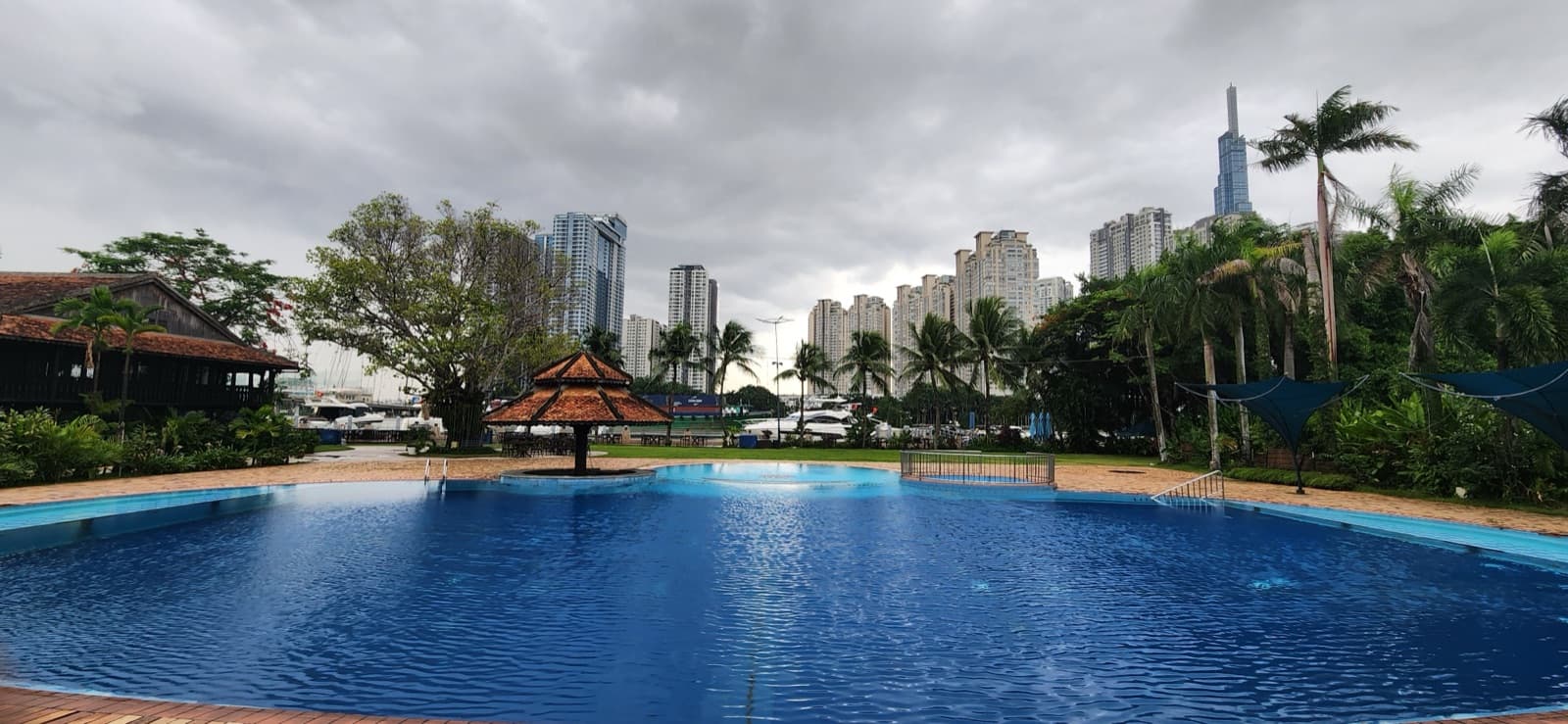Lan Anh Garden riverside pool and lawn with a pagoda-style gazebo and Ho Chi Minh City skyline