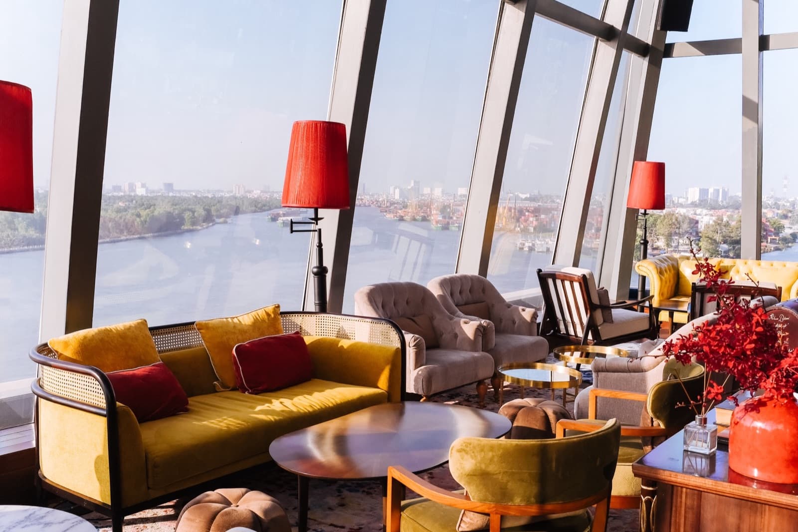The Muse's indoor lounge seating at Mia Saigon, unoccupied, with full-height glazing over the river.