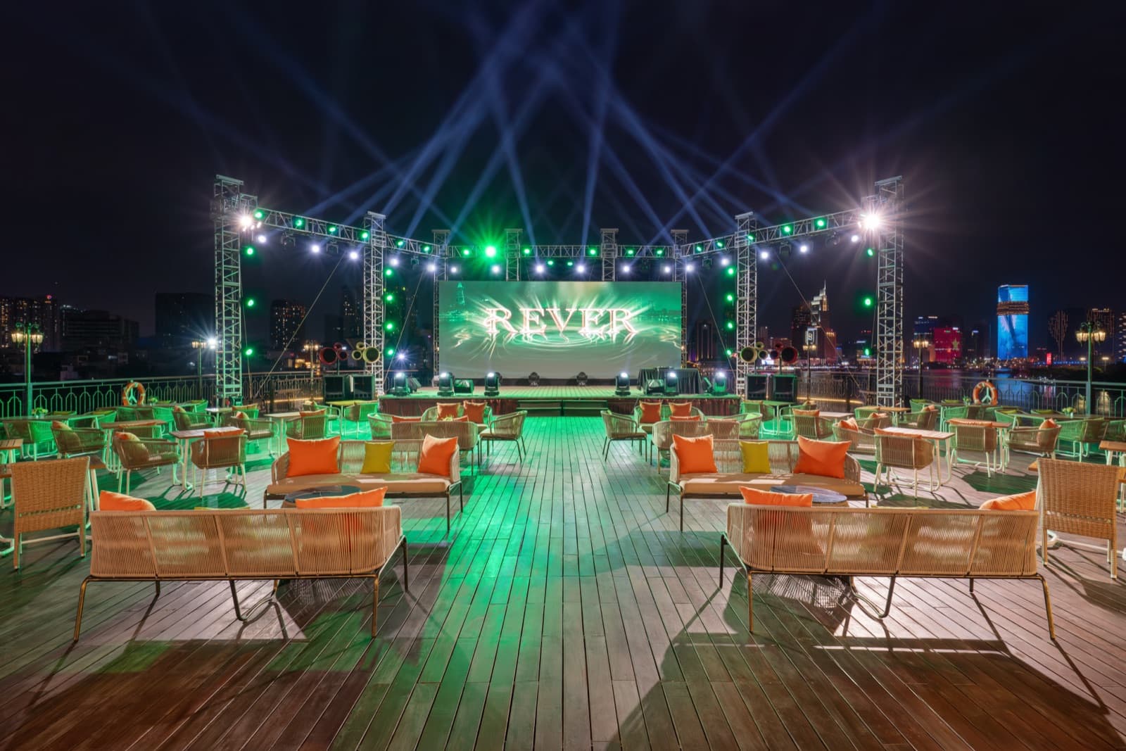 REVER Sky Lounge stage set with green lighting and lounge chairs