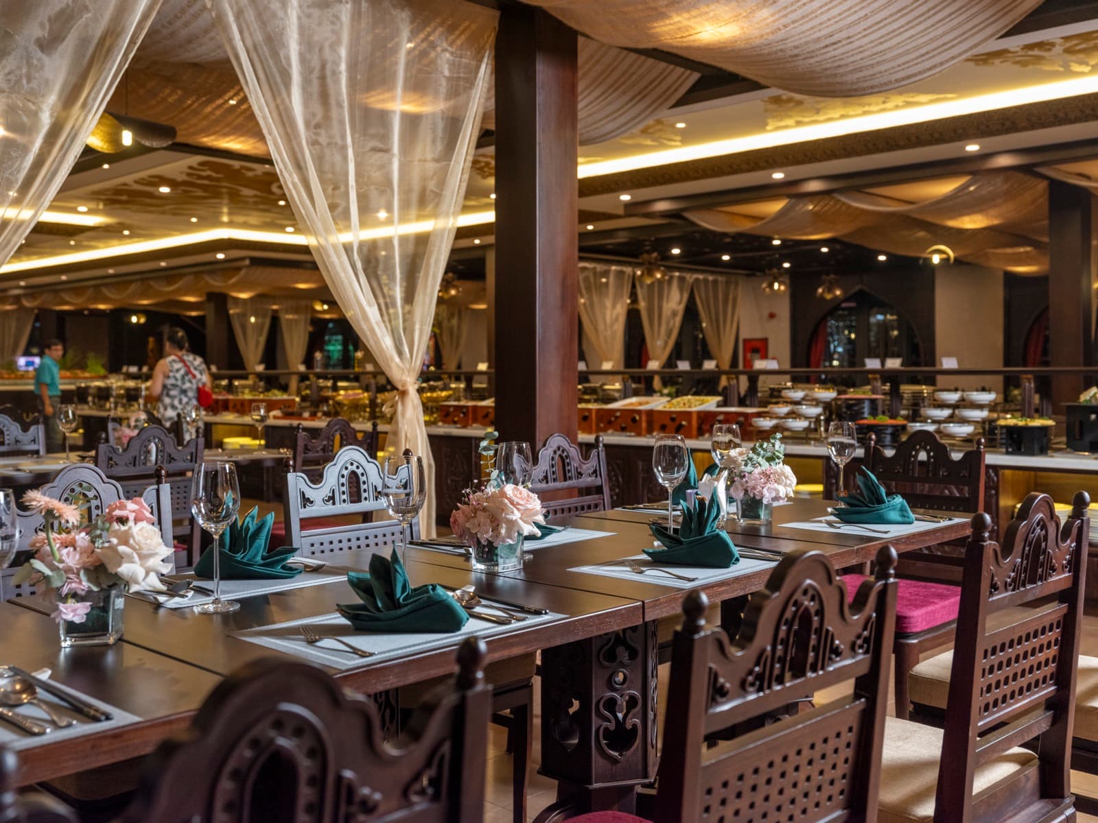 Reveranga dining room set with tables beneath draped fabric
