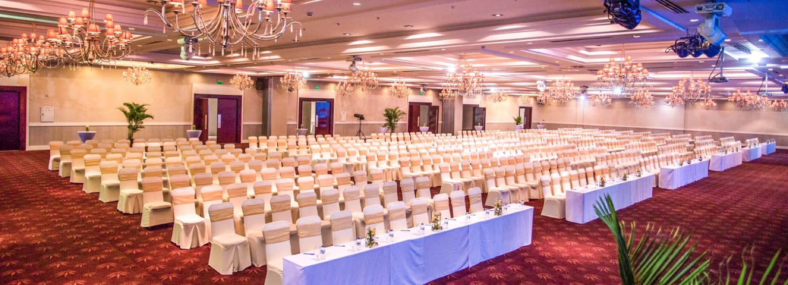 Grand Ballroom at Riverside Palace laid out with round tables for a banquet, unoccupied.