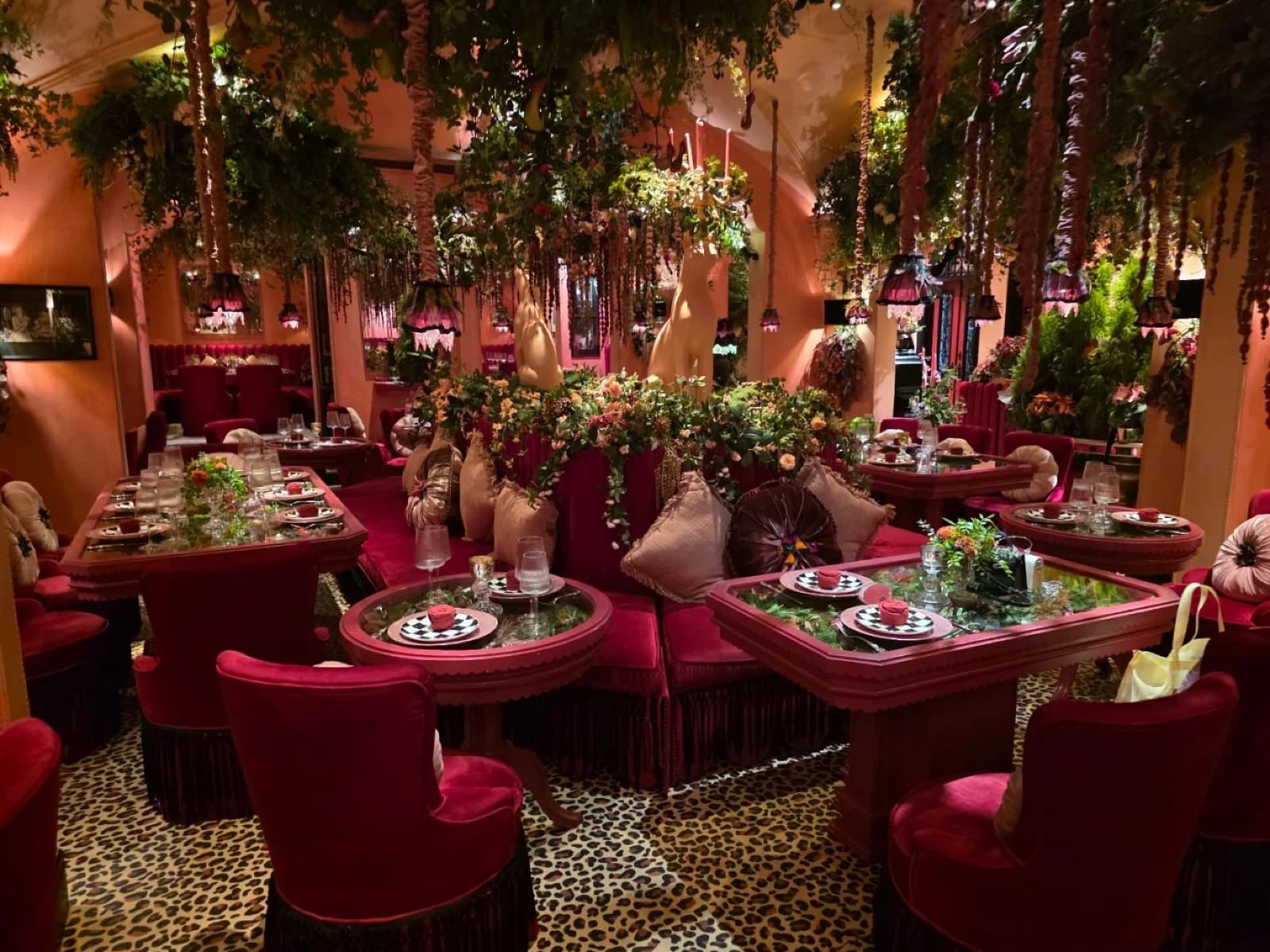 The Venue at Rose Villa Saigon dressed for a banquet, long dining tables under a hanging floral and greenery canopy