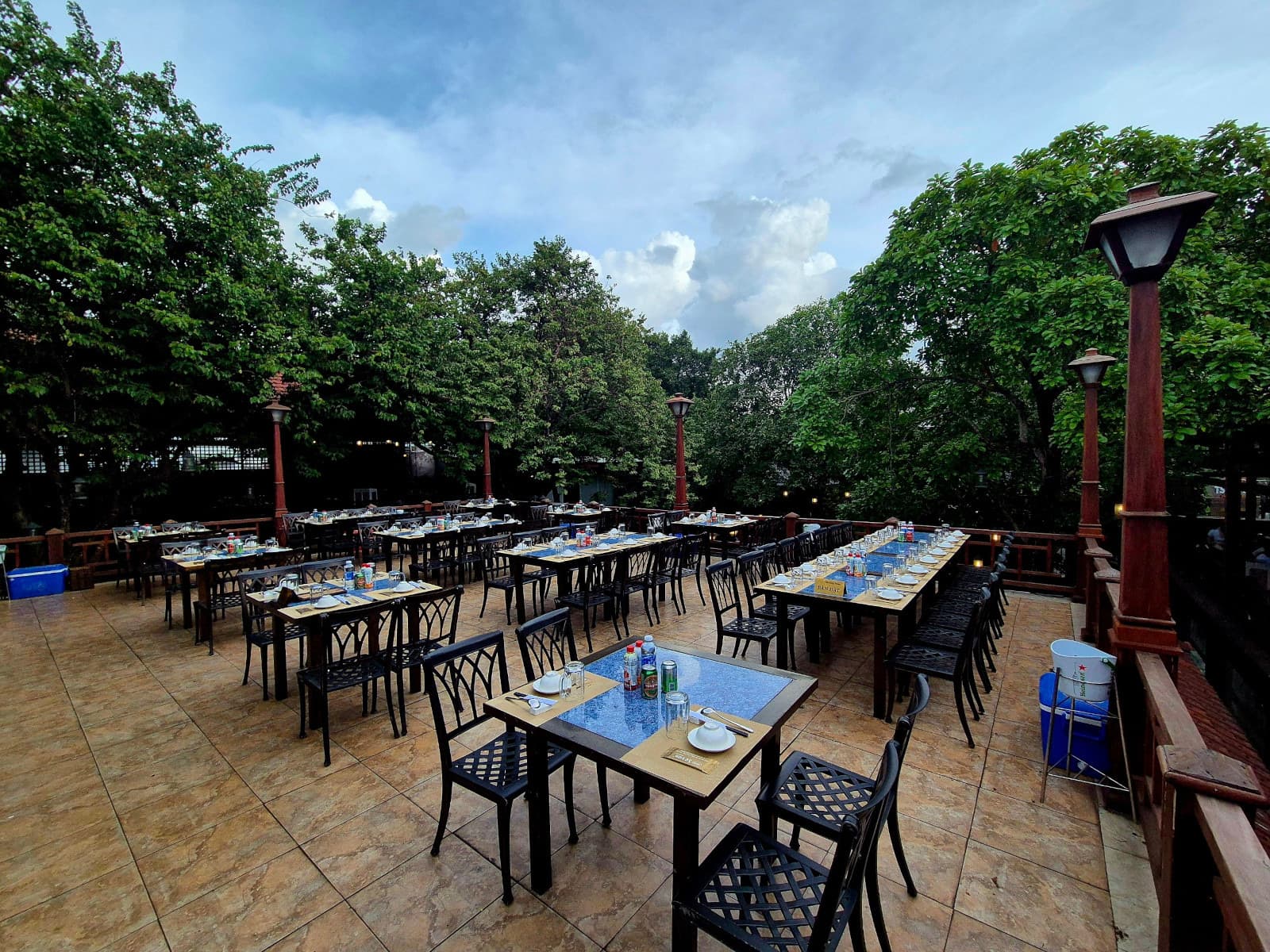 Long banquet-style tables set on an open-air terrace