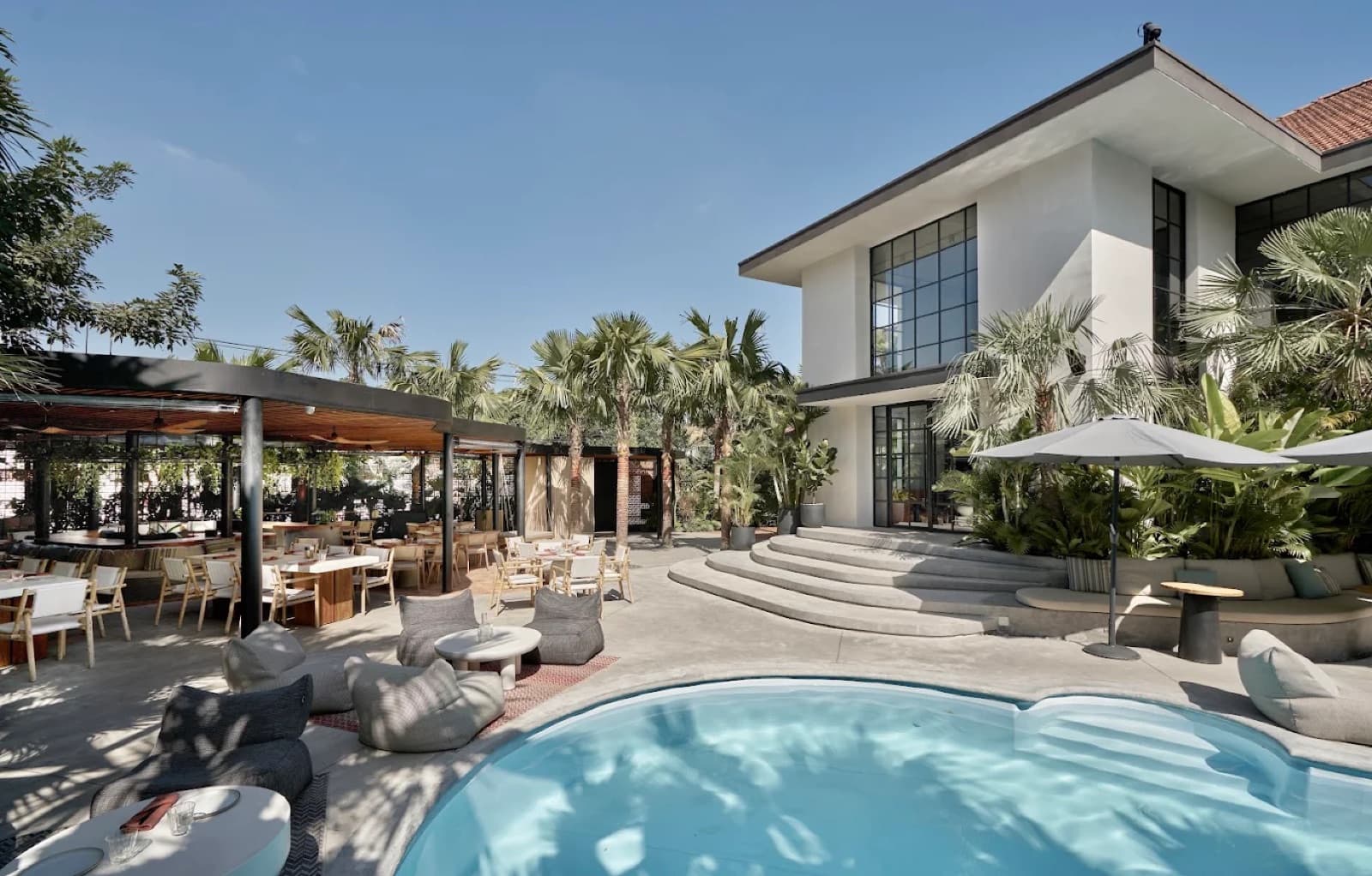 Exterior view of The Brix's pool deck and two-storey building, unoccupied.