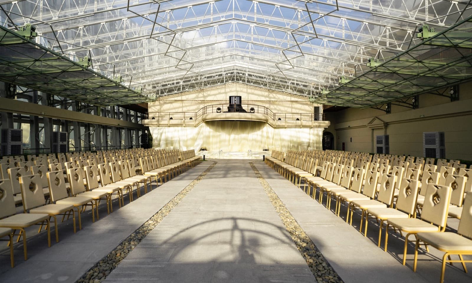 Space Above rooftop ceremony courtyard set with rows of empty chairs along a central aisle