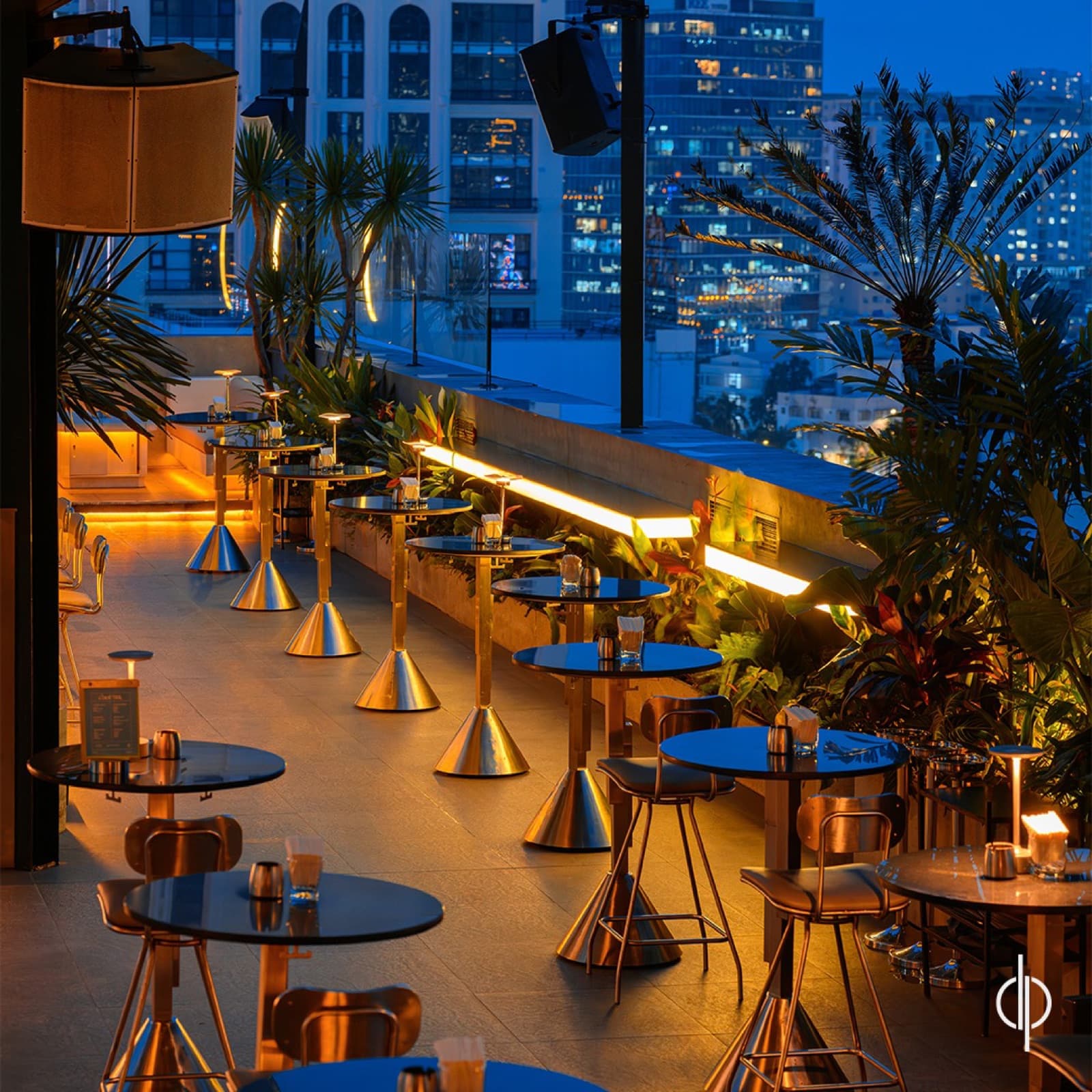 The rooftop bar and seating area at Zion Sky Lounge & Dining in the evening, unoccupied.
